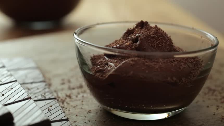 Chocolate shavings are sprinkled on chocolate pudding