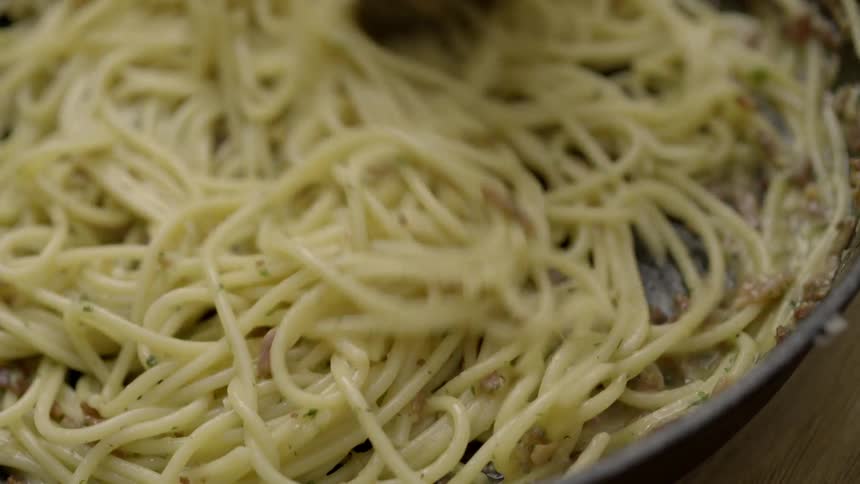 Pasta being stirred in a pan