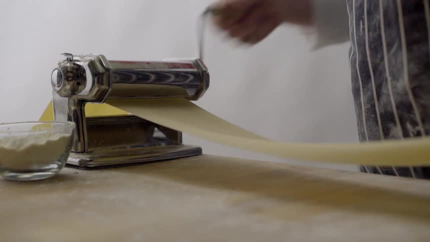 Pasta going through a machine
