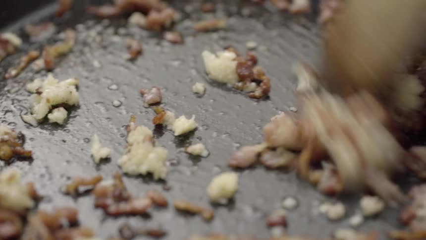 Food is cooked and stirred in a pan