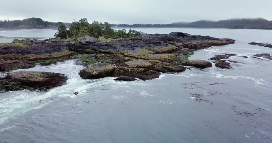 Waves crash into a rocky island