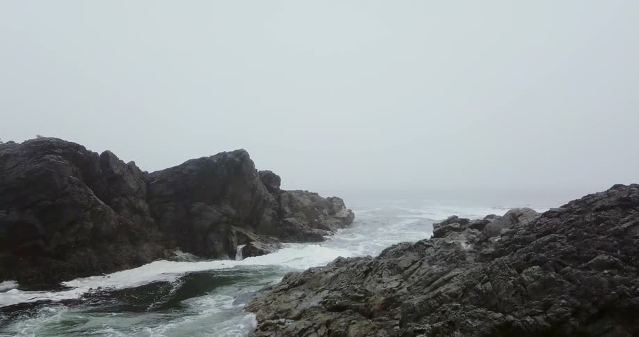 Water crashing up on rocks on shore