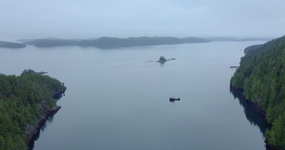 Boat floating on a large body of water on a cloudy day