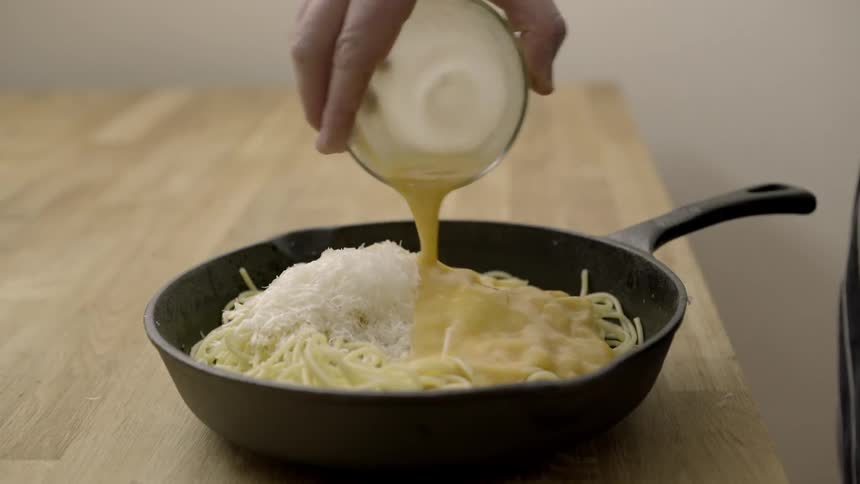 A pan of noodles is stirred