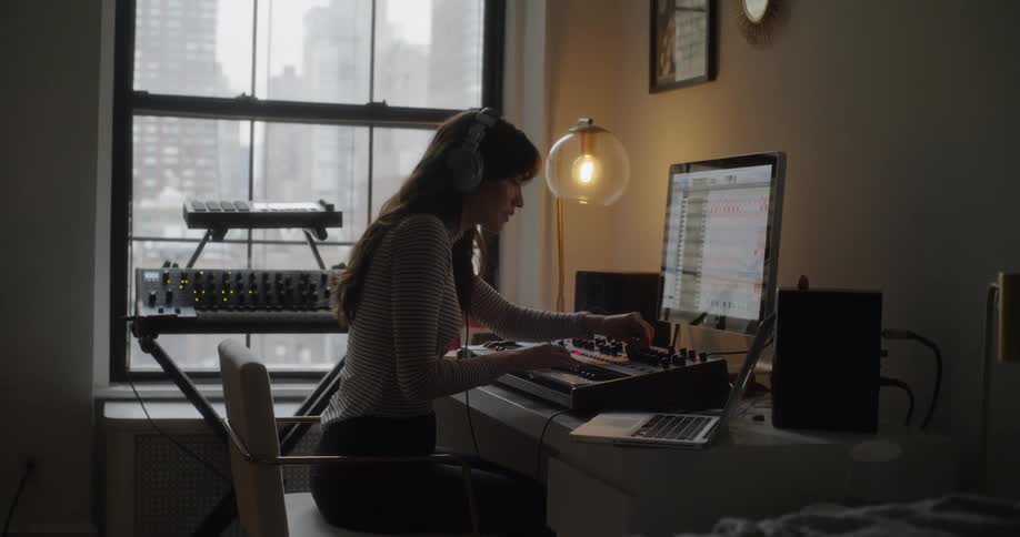 Woman composing on keyboard in front of computer