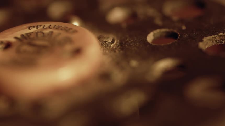 The metal cylinder has many holes in it