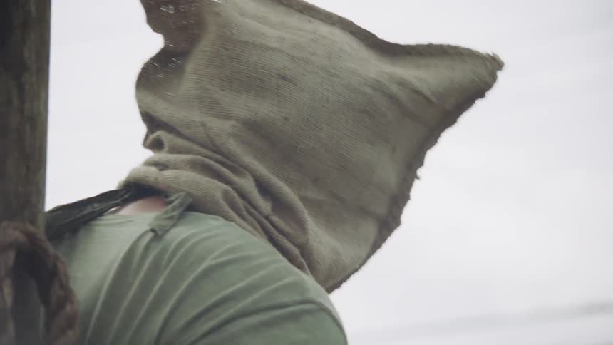 Soldier puts a sack on a person's head