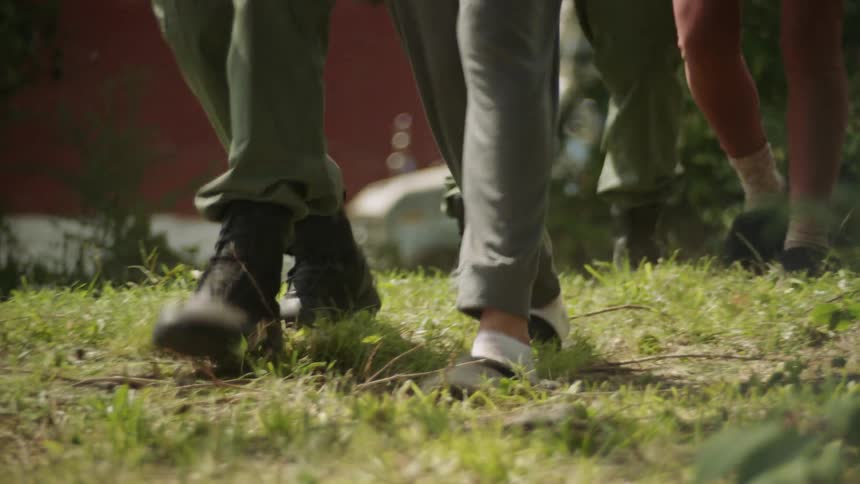 Military people walking with a civilian amongst them