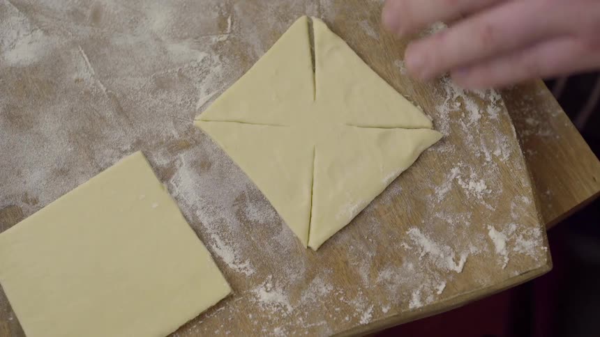 Man cuts some food and arranges it on a board
