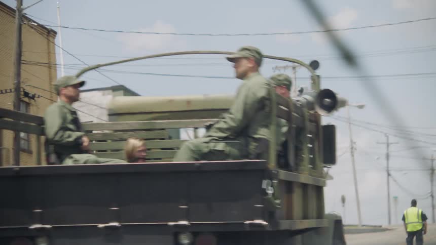 Soldiers sitting in the back of a military vehicle