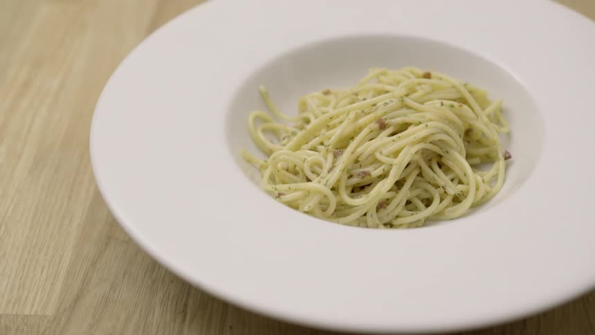 Pasta being served in a bowl
