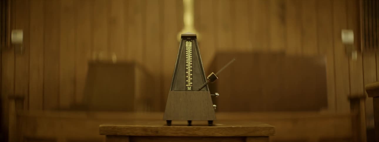A metronome ticks in a wood room