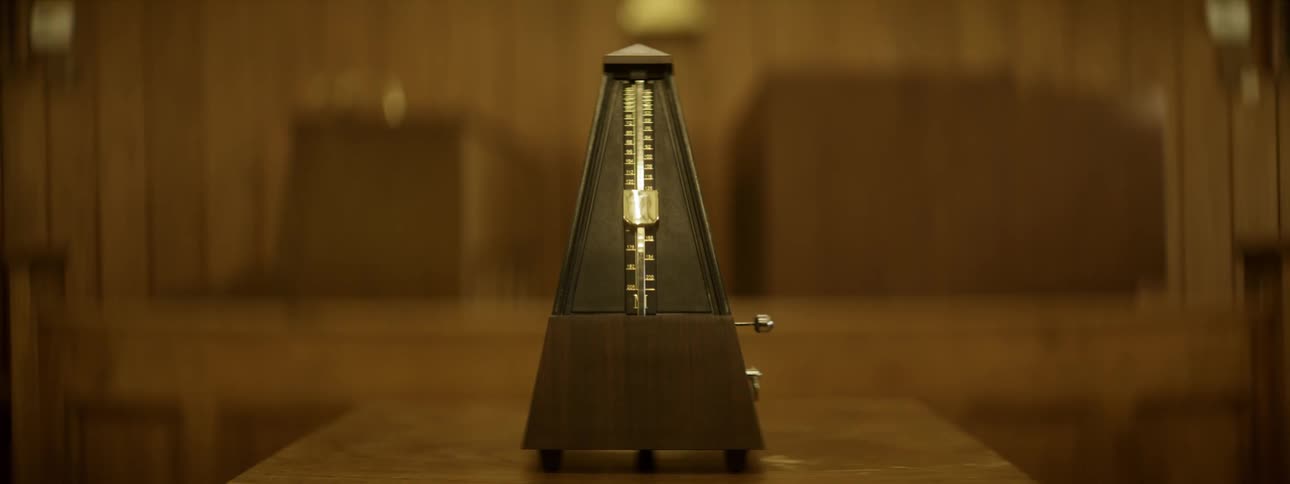 Still metronome on a brown table