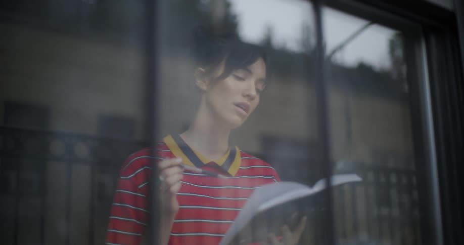 A woman reads from a book and speaks aloud