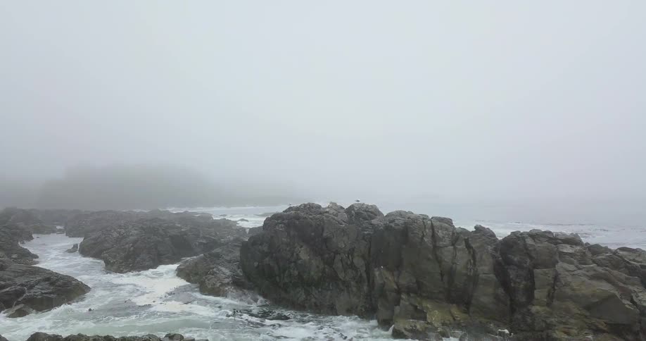Water crashing up on rocks on shore