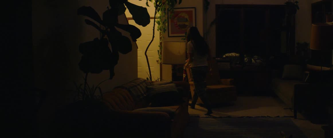 Woman answers the front door at night