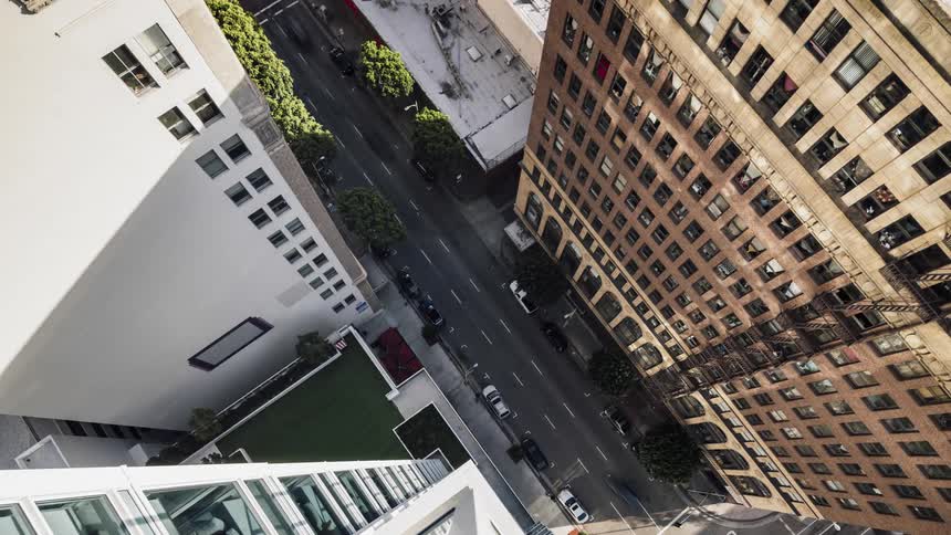 Cars drive on a city street