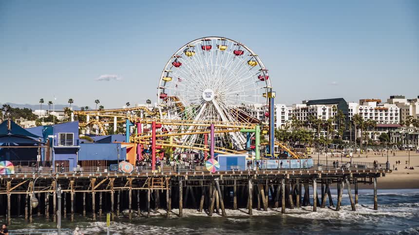 The people travel around the pier on a sunny day
