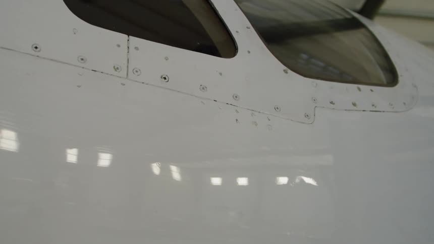 The plane in the hangar is painted white