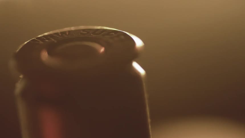 A shotgun shell is standing up on a table