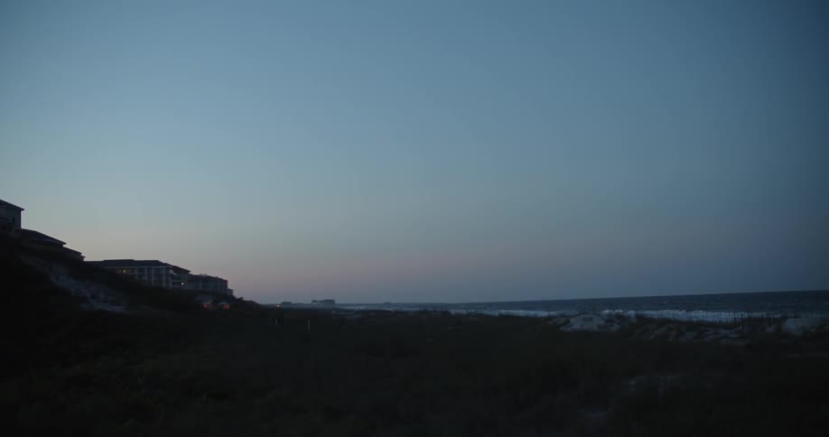 The sun is nearly set on the shore