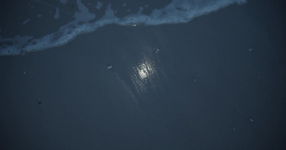The tide flows onto the beach shore