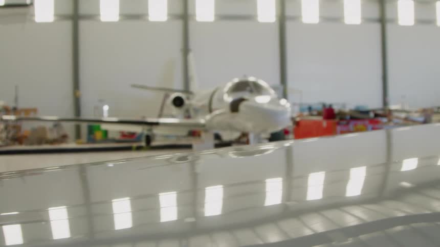 White airplane sits in a large building