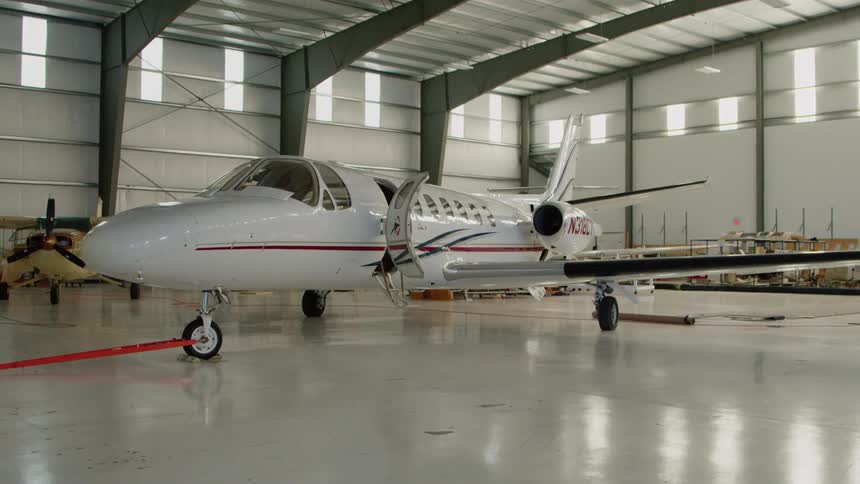 White airplane in a large airplane garage