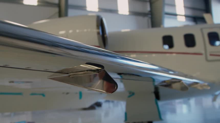 An airplane sits parked in a hangar