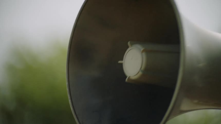 Person holds up a megaphone