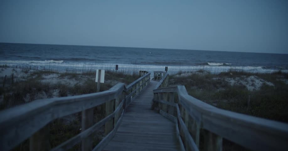 The waves crash against the shore in the distance