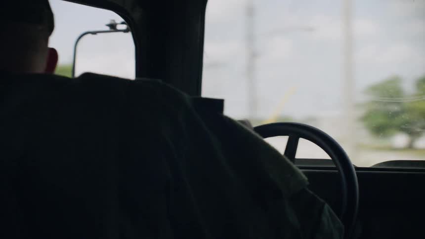 Person steering a vehicle in a neighborhood