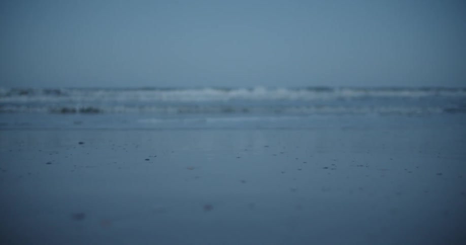 The tide flows onto the beach shore