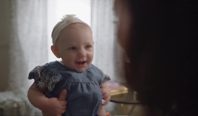 Woman holds a smiling baby