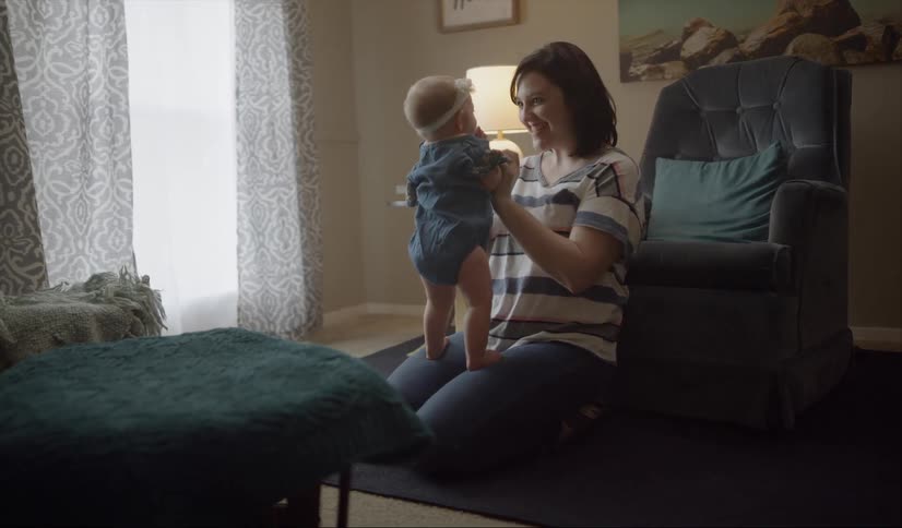 A woman holds a baby on her lap