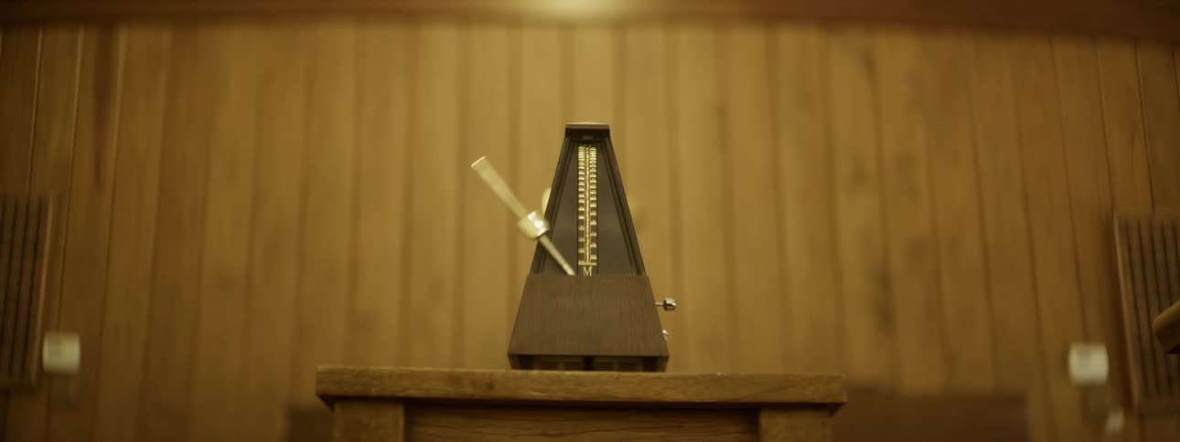 A metronome ticks in a wood room