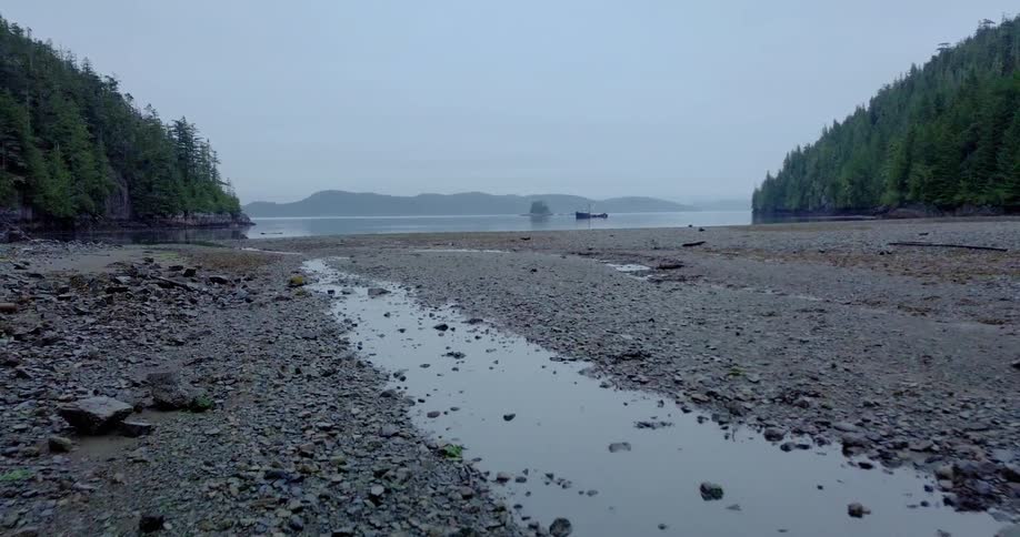 Water seeping through rocks near a large body of water