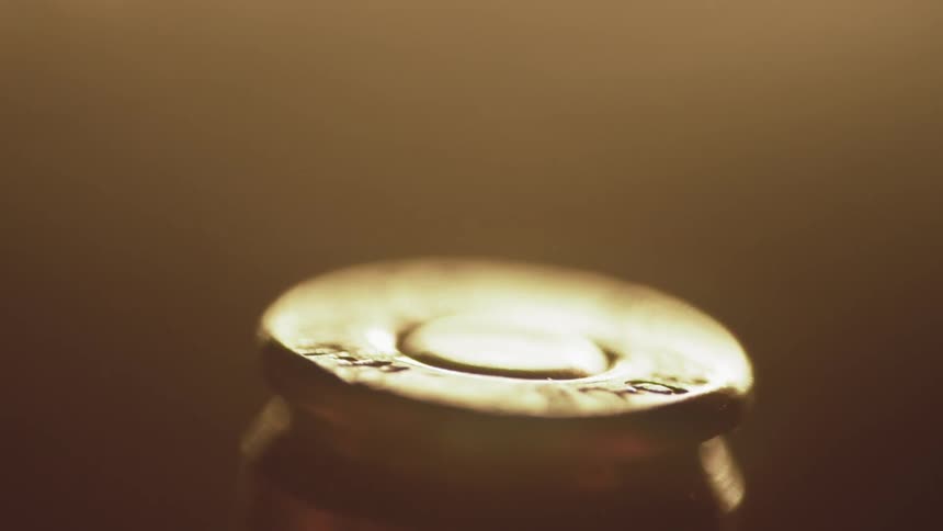 The numbers etched on the bottom of a bullet are lost in the glare