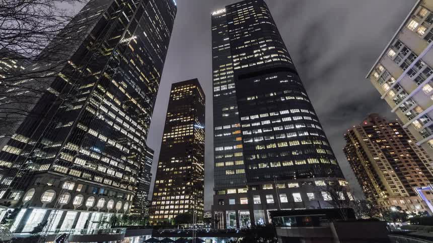 Tall skyscrapers lit up at night