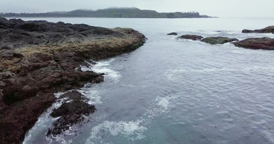 The water is rough around the rocky coast