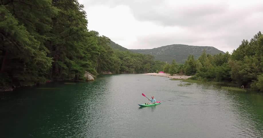 A person is rowing the canoe in the water