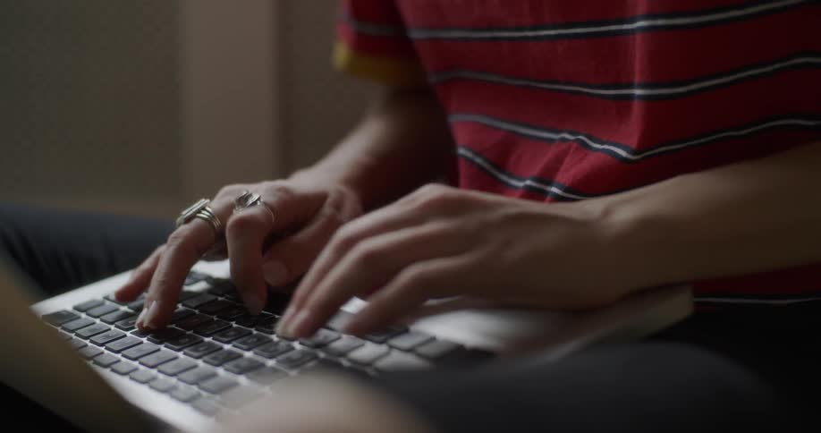 Person typing on a laptop keyboard