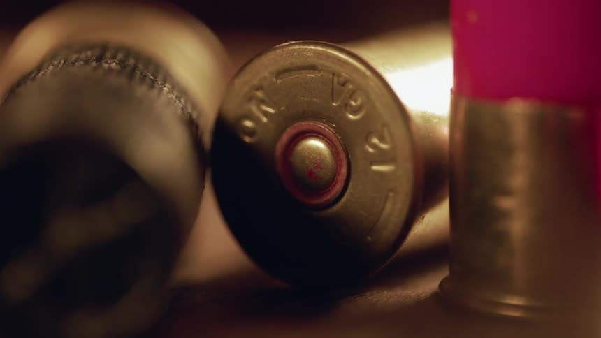 Shotgun casings are strewn across a table