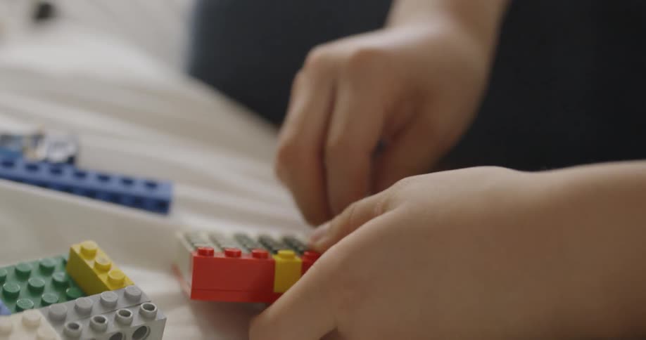 A child plays with legos on the floor