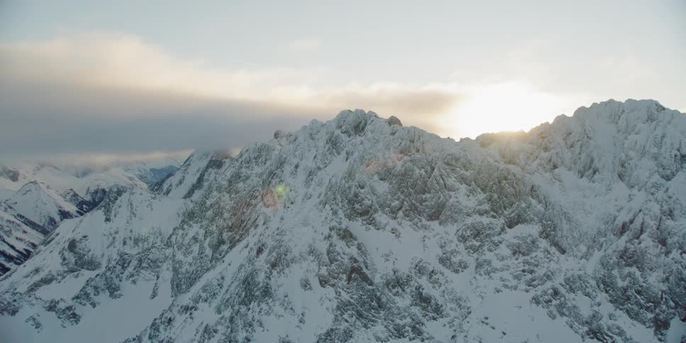 Now covered mountains sit under a blue sky