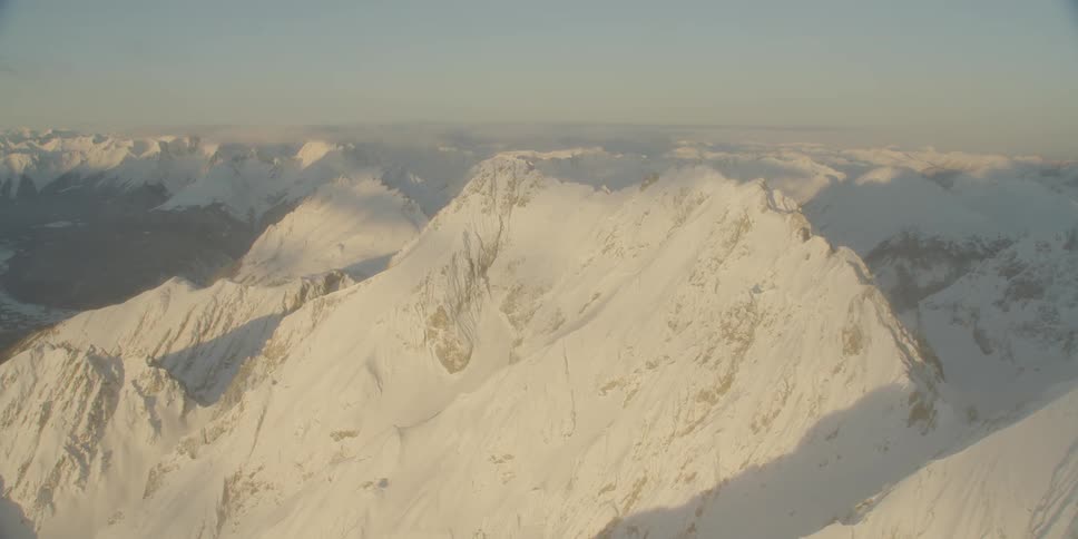 Sun shines down over snowy mountains