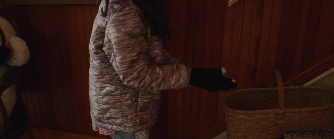 A young girl removes gloves from a basket