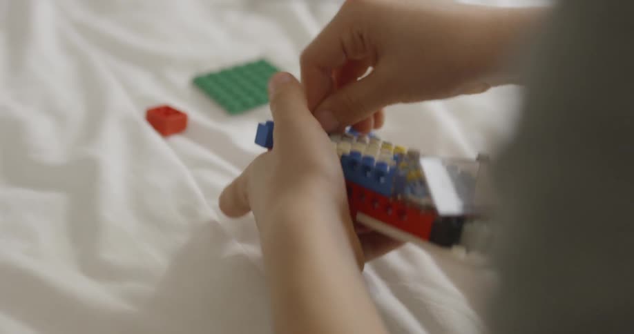 Child plays with colored building blocks