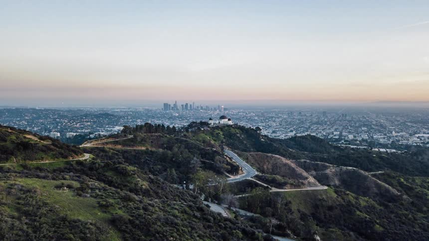 Traffic flows on a winding road in the hills outside los angeles at dusk