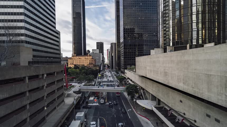 Cars drive on a city street